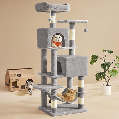 Feandrea cat tree with three cats - white cat in upper condo, golden cat in hammock, tabby kitten on floor next to product box