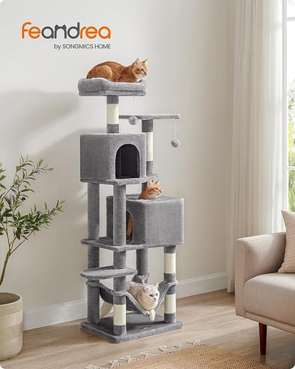Feandrea by SONGMICS HOME - three cats on gray multi-level cat tree in bright living room - orange tabby on top perch, tabby in condo, white cat in hammock